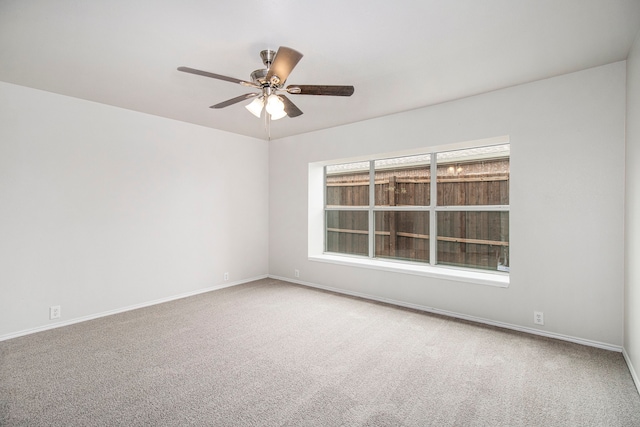 spare room with carpet flooring and ceiling fan