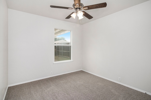 spare room featuring carpet floors and ceiling fan