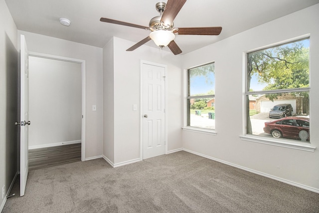 unfurnished bedroom with light carpet and ceiling fan