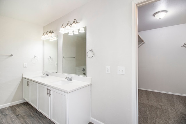 bathroom featuring dual vanity and hardwood / wood-style floors