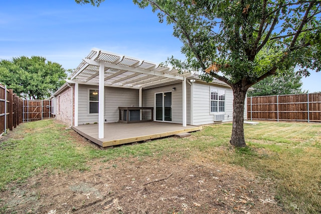 rear view of property featuring a pergola, a yard, and a deck