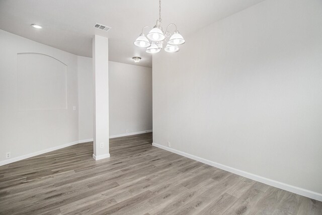 interior space featuring hardwood / wood-style floors and a chandelier