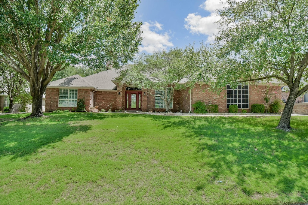 ranch-style home with a front lawn