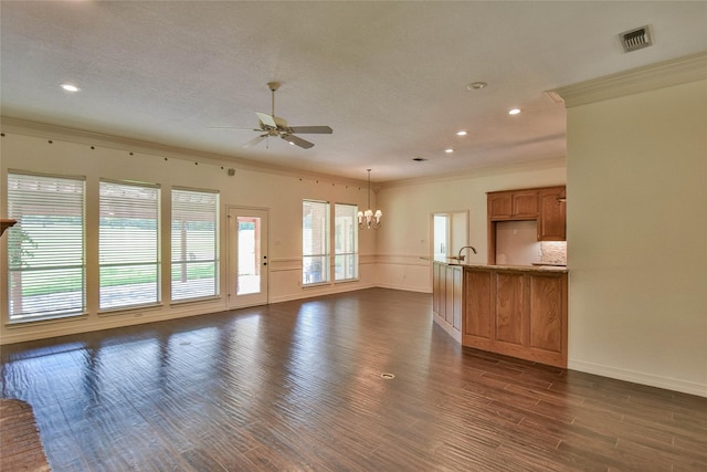 unfurnished living room featuring ceiling fan with notable chandelier, dark wood-type flooring, and ornamental molding