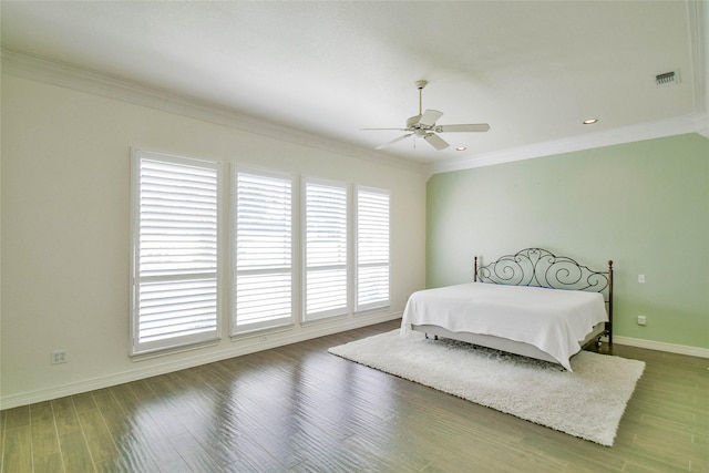 bedroom featuring crown molding, dark wood-type flooring, and ceiling fan