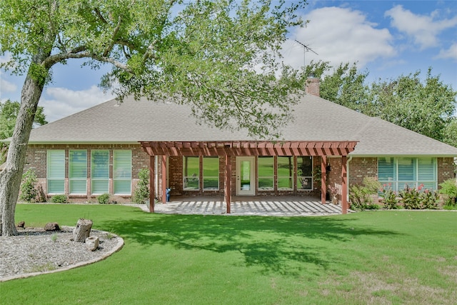 rear view of house with a pergola, a yard, and a patio area