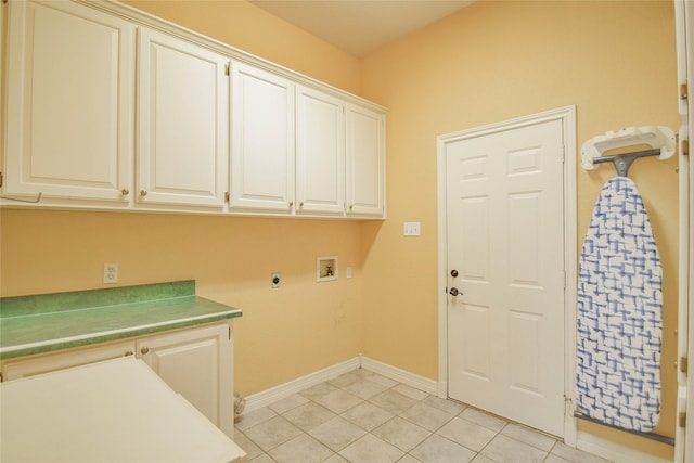 clothes washing area with washer hookup, electric dryer hookup, light tile patterned floors, and cabinets