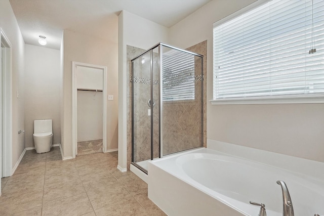 bathroom featuring plenty of natural light, shower with separate bathtub, and tile patterned flooring