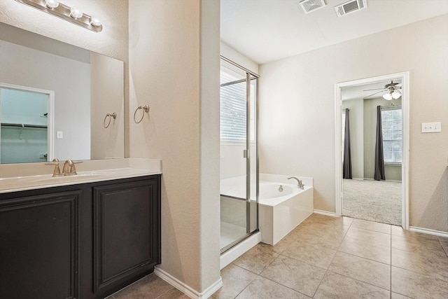 bathroom featuring tile patterned flooring, vanity, a wealth of natural light, and ceiling fan