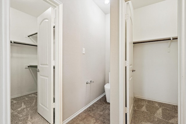 bathroom featuring toilet and tile patterned floors