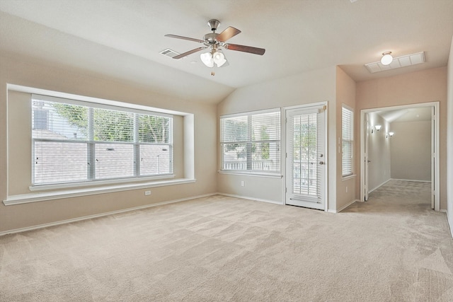 carpeted empty room featuring ceiling fan and lofted ceiling