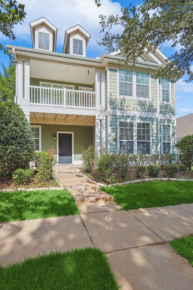 view of front of house with a balcony