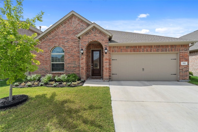 view of front of house with a garage and a front yard