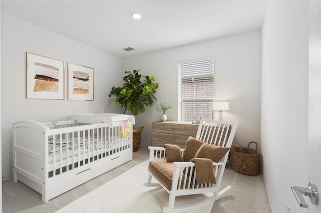 carpeted bedroom with a crib