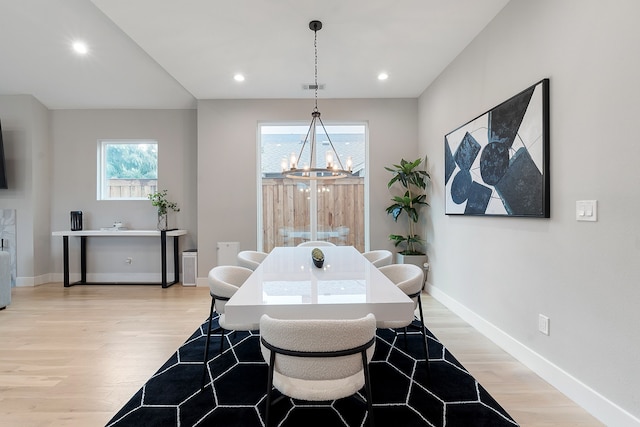 dining room featuring light hardwood / wood-style flooring and a notable chandelier