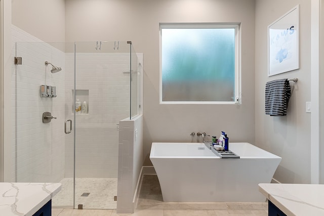 bathroom featuring vanity, independent shower and bath, and tile patterned flooring