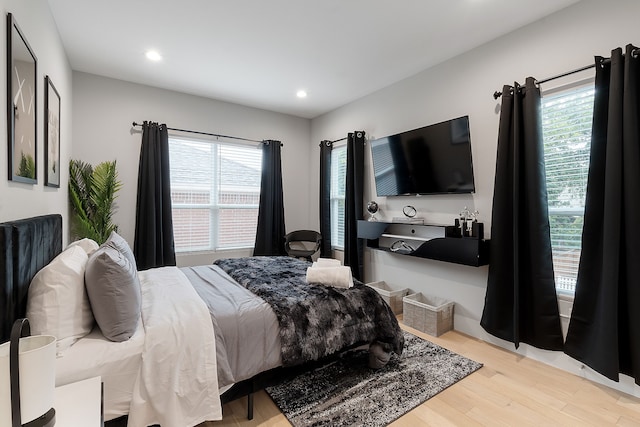 bedroom featuring light hardwood / wood-style floors and multiple windows