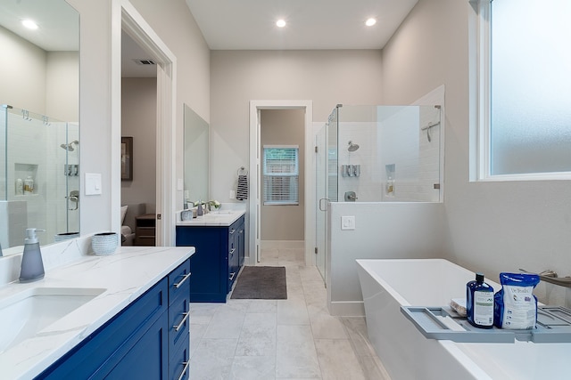 bathroom with vanity and independent shower and bath