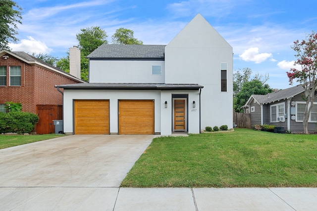 contemporary house featuring a front lawn and a garage