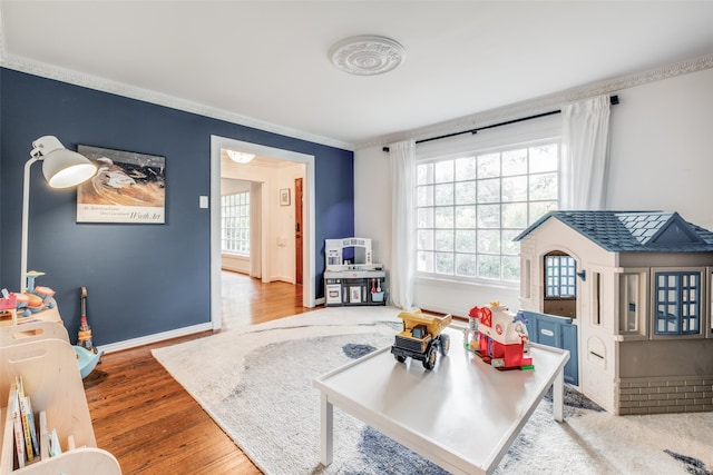 living room with crown molding and hardwood / wood-style floors