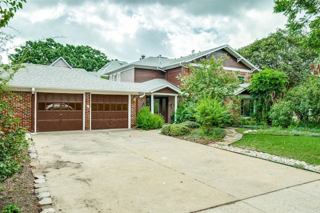 view of front of house with a garage and a front yard