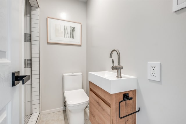 bathroom featuring vanity, tile patterned flooring, and toilet