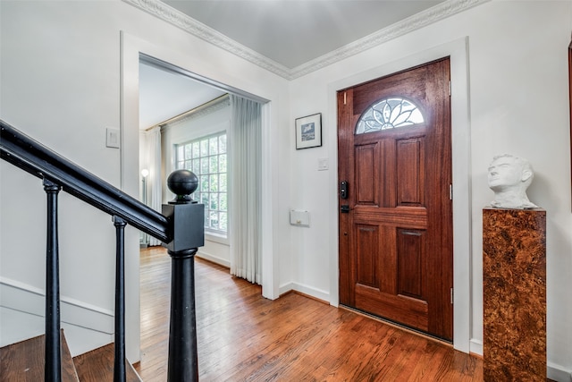 foyer entrance featuring hardwood / wood-style flooring and crown molding