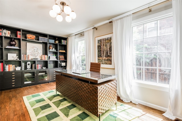 office with a notable chandelier and hardwood / wood-style flooring