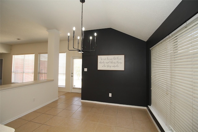 unfurnished dining area featuring lofted ceiling, ornate columns, and light tile patterned flooring