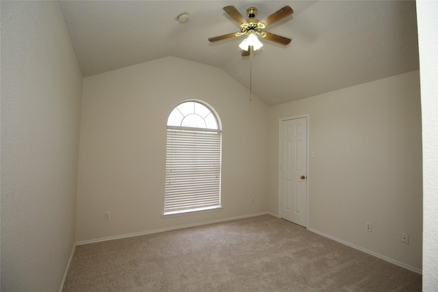 unfurnished room featuring ceiling fan, light colored carpet, and lofted ceiling