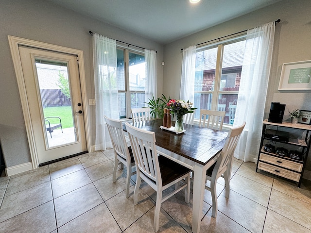 tiled dining area with a healthy amount of sunlight