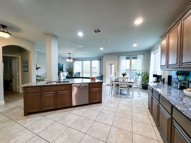 kitchen featuring light tile patterned floors, dishwasher, ceiling fan, light stone countertops, and sink