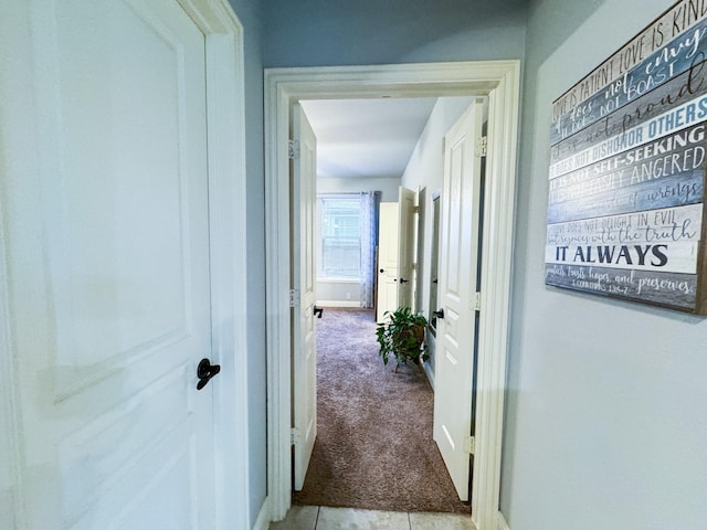 hallway featuring light colored carpet