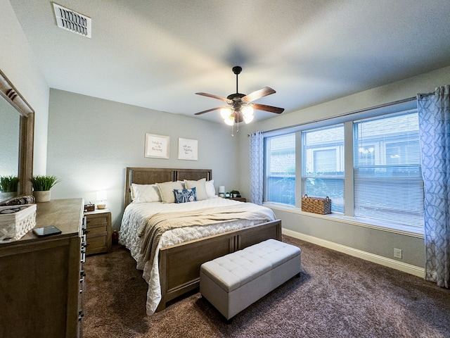 bedroom with dark colored carpet and ceiling fan