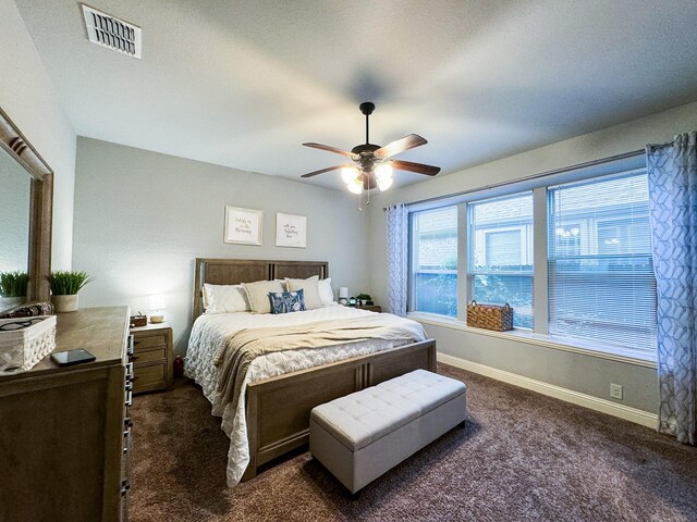 bedroom with ceiling fan and dark colored carpet