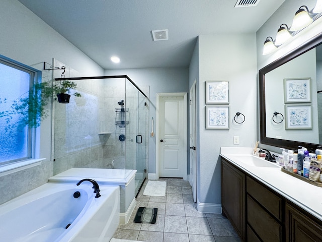 bathroom featuring independent shower and bath, vanity, and tile patterned flooring