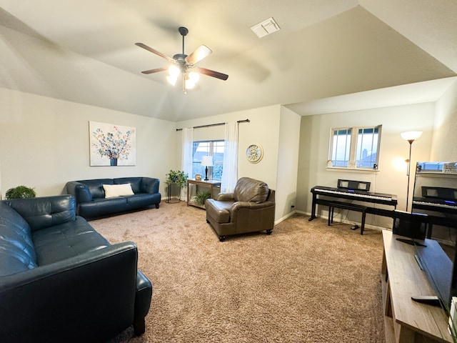 carpeted living room with lofted ceiling and ceiling fan