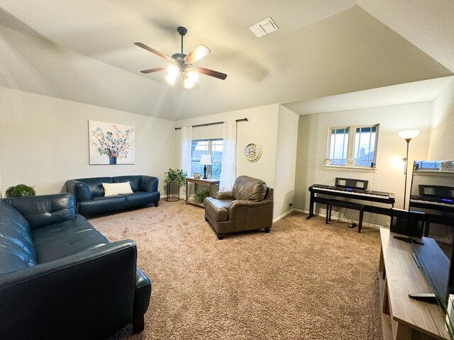 living room with carpet floors, ceiling fan, and vaulted ceiling