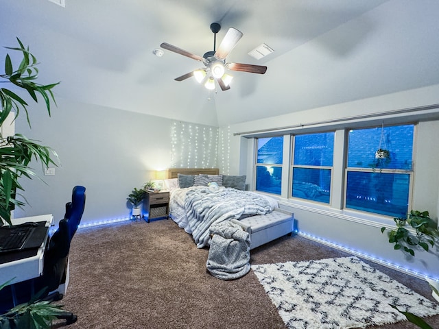 bedroom featuring ceiling fan, vaulted ceiling, and dark carpet