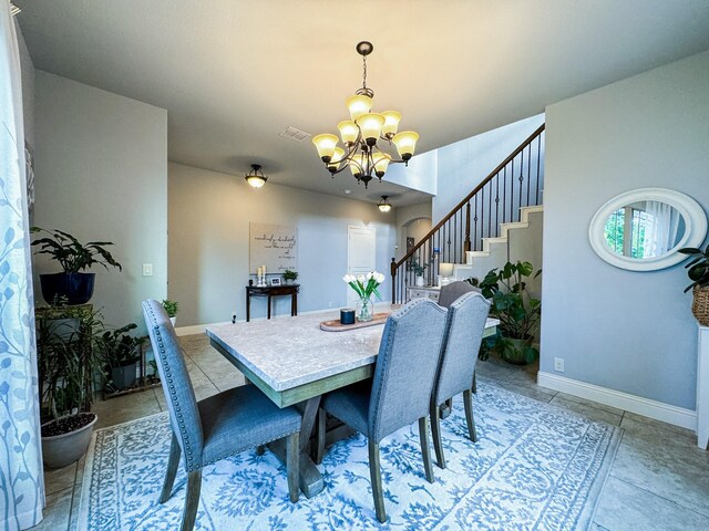 dining room featuring light tile patterned flooring and an inviting chandelier