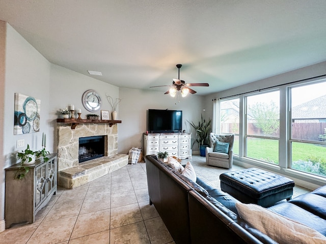 living room with a fireplace, light tile patterned floors, and ceiling fan