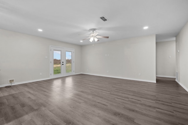 unfurnished room featuring dark wood-style floors, french doors, visible vents, and baseboards