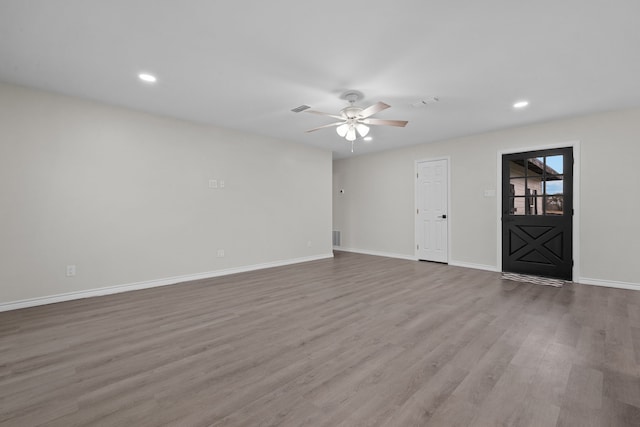 unfurnished living room with hardwood / wood-style flooring and ceiling fan