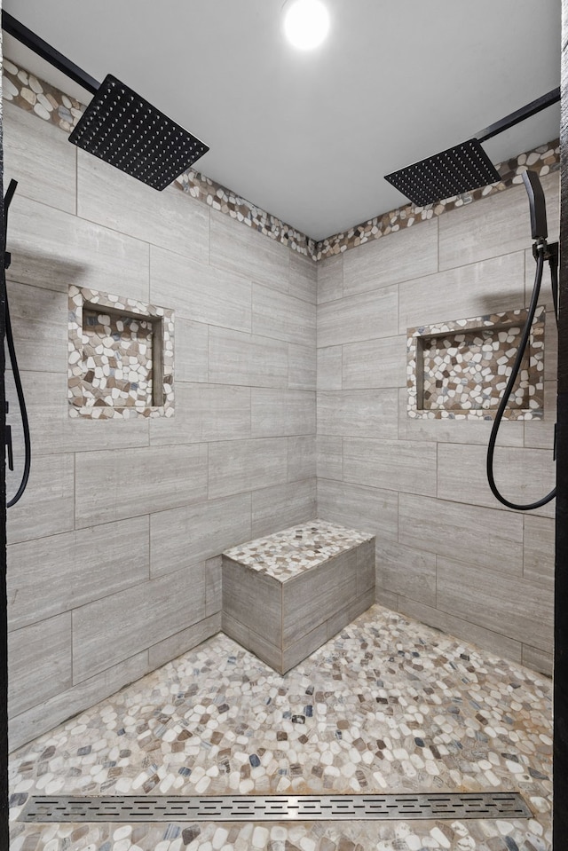 bathroom featuring a tile shower