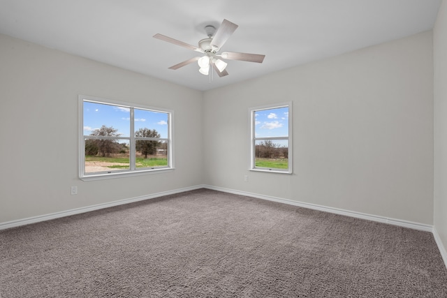 unfurnished room featuring carpet, plenty of natural light, baseboards, and ceiling fan