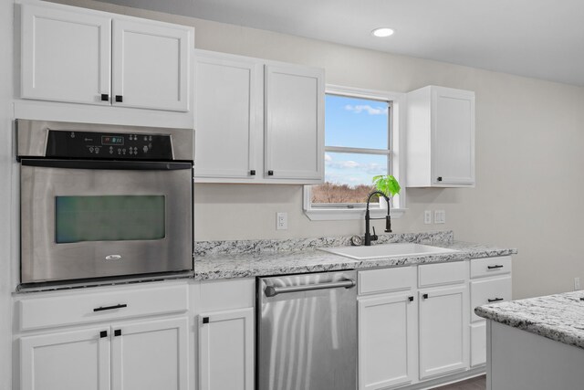 kitchen featuring white cabinetry, appliances with stainless steel finishes, and sink