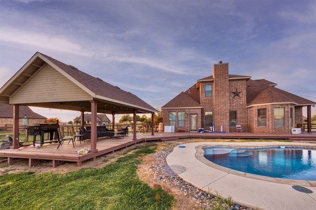 view of pool with a deck and a gazebo