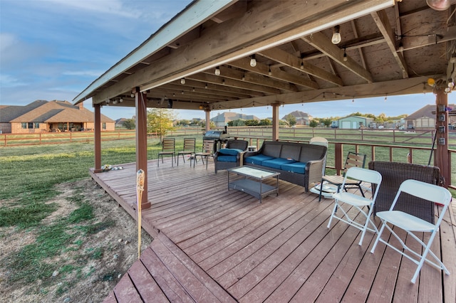 wooden terrace featuring an outdoor living space and a yard