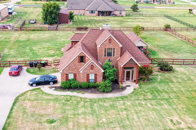 view of front facade with a rural view and a front yard