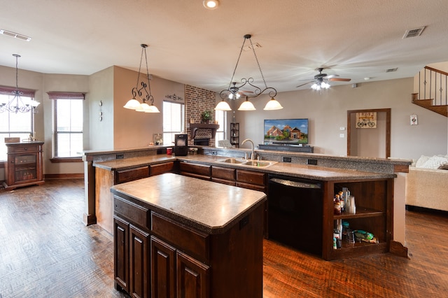 kitchen featuring dishwasher, a center island, dark hardwood / wood-style floors, pendant lighting, and sink